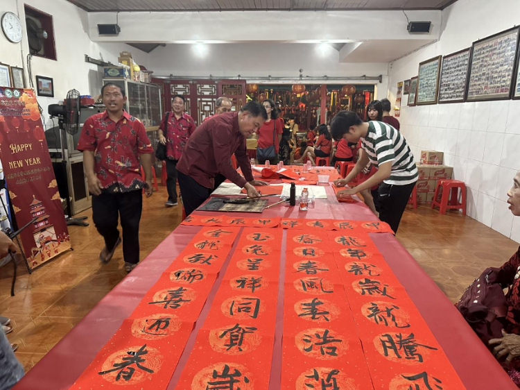 茍皓東為華人朋友現(xiàn)場寫春聯(lián)送福字。巴陵康孔子學(xué)院供圖