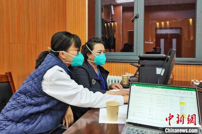 8月9日，楊蘇喬(左)在拉薩方艙醫(yī)院指揮部讀取艙內(nèi)患者胸部CT?！∈茉L者供圖