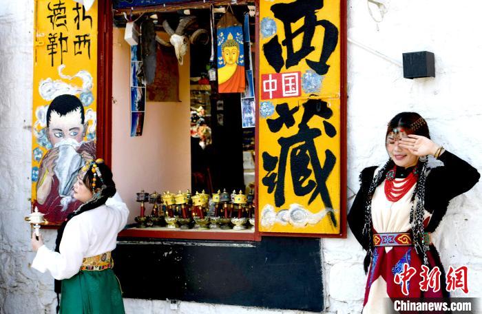 4月17日，游客身著藏式元素服裝在拉薩八廓街拍照留念?！±盍?攝