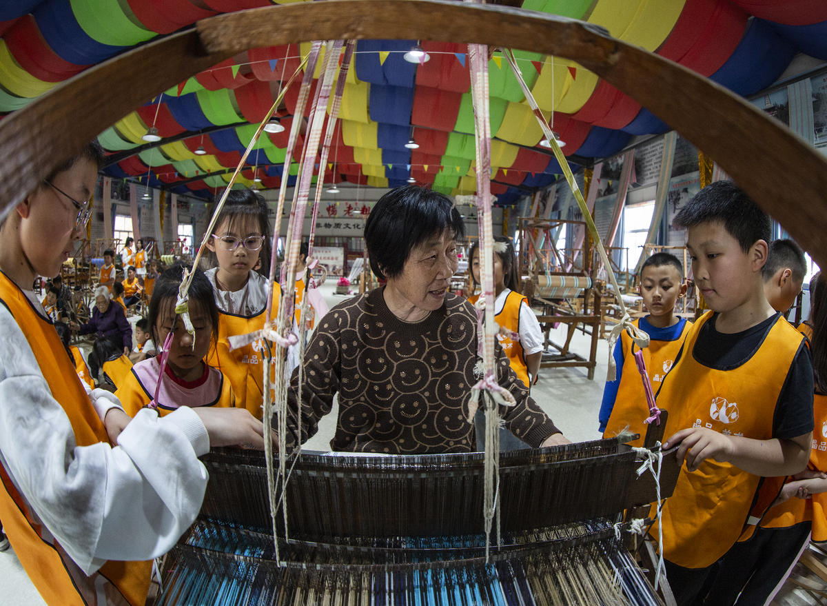 5月1日，在山西省永濟市開張鎮(zhèn)東開張村的惠暢土布文化園，土布制作技師教游客織布技藝。 來源：人民圖片網(wǎng)