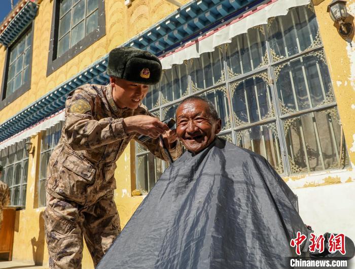 圖為阿里軍分區(qū)某邊防團(tuán)官兵為駐地群眾理發(fā)迎藏歷新年?！〉┰鰝愔?攝